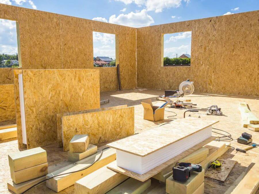 Construction site with insulated wooden panels assembled.